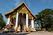 Vientiane, Laos - Pha That Luang, Other structures on the ground include a bell tower, several stupas, a number of pavilions sheltering images of the Buddha. 